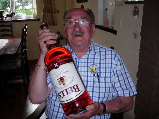 Gordon Cragg on his eigtieth birthday with large bottel of whisky